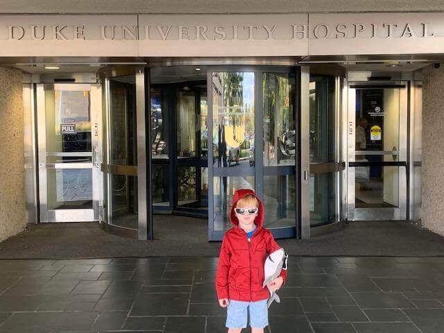 Gavin standing at the entrance of Duke University Treatment Center